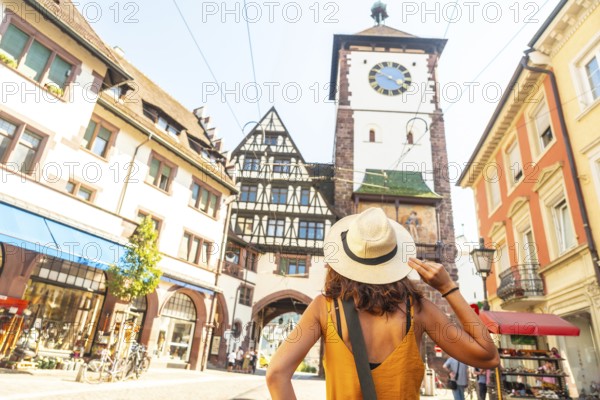 A female tourist at Schwabentor in the city of Freiburg im Breisgau, Germany, Europe
