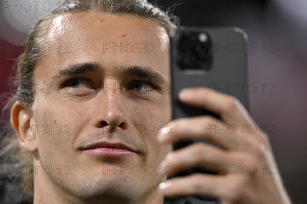 Tennis player Alexander Zverev visiting a Bundesliga match, portrait, takes selfie with smartphone, Allianz Arena, Munich, Bavaria, Germany, Europe