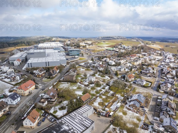 Bird's eye view of industrial area and neighbouring residential buildings in winter landscape, Schopfloch, Freudenstadt district, Germany, Europe