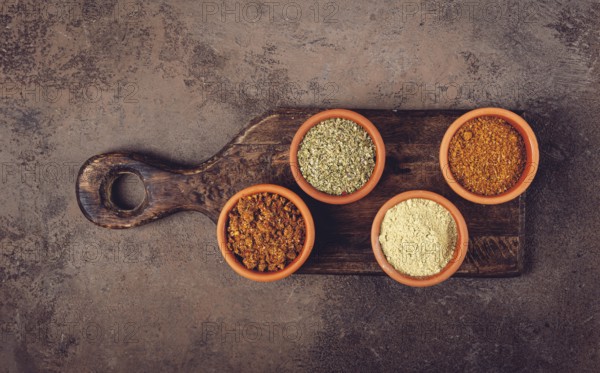 Georgian spices, in ceramic bowls, assortment, set of spices, utsho, adjika, Svan salt, ground coriander, top view, no people