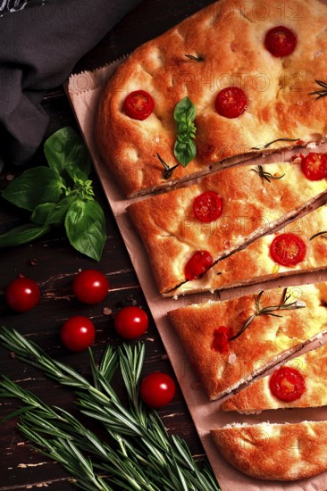 Focaccia, Italian flatbread, with cherry and rosemary, close-up, garlic bread, top view, vertical, no people, homemade