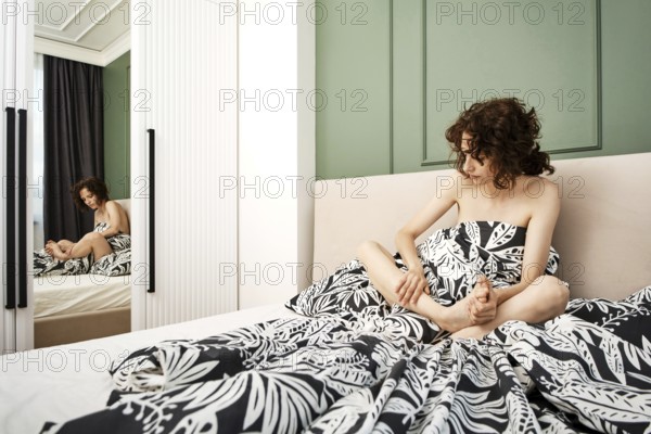 Woman woke up because her leg cramped, she massages her foot