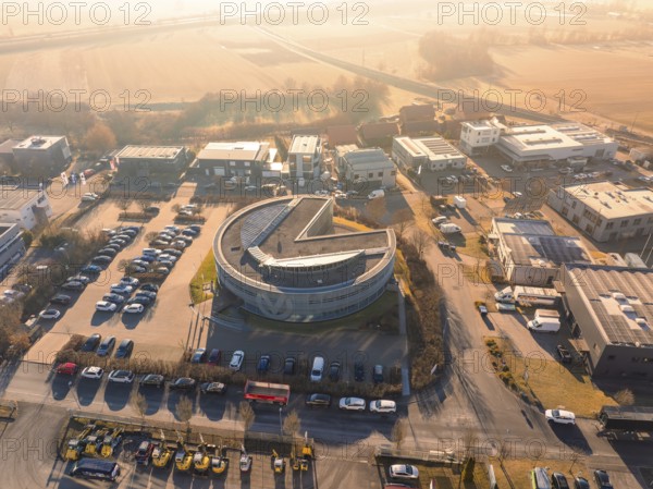 Round building in an industrial area with parked cars and street in the background in sunny weather, Gültstein, Herrenberg, Germany, Europe