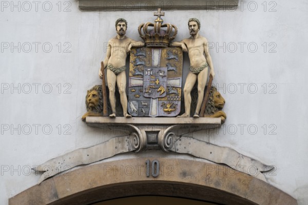 Coat of arms with crown and two men, Stormgade 10, Copenhagen, Denmark, Europe