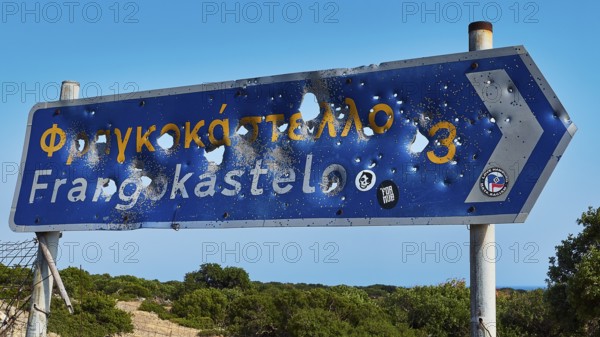 Road sign, bullet holes, shot up road sign, Frangokastello, Venetian fortress, fortress, Sfakia, West Crete, south coast, island of Crete, Greece, Europe
