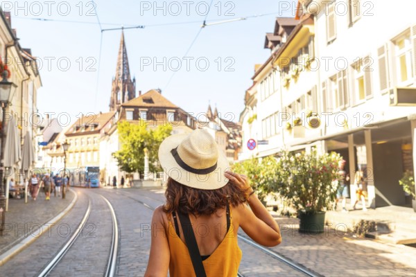 Walking past the Freiburg Minster in the city of Freiburg im Breisgau, Germany, Europe