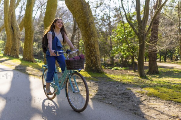 Young woman riding a vintage bicycle through a sunlit park, enjoying the fresh air and vibrant surroundings while embracing leisure and freedom