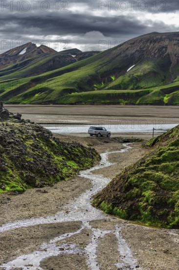 Off-road vehicle in volcanic landscape, Moss-covered mountains, Rhyolite mountains, Volcanic landscape, Landmannalaugar, Fjallabak nature reserve, Icelandic highlands, Suðurland, Iceland, Europe