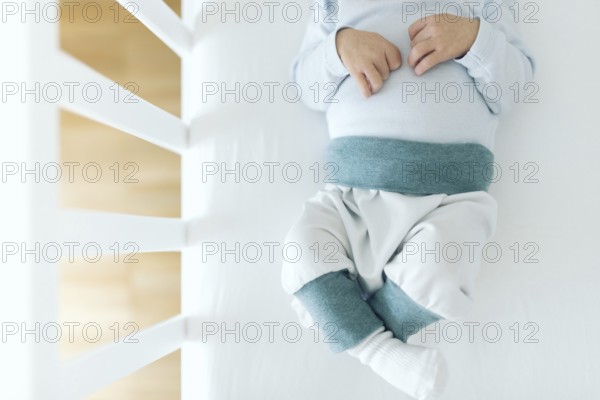 directly above view of four day old newborn baby boy in baby crib