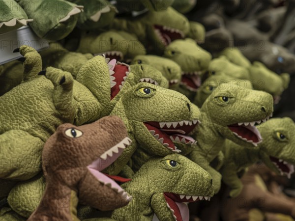Long row of soft toy dinosaurs in a shop