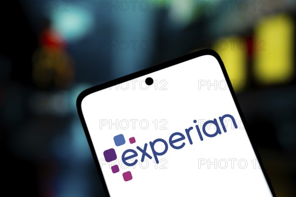experian logo is displayed on smartphone. Experian plc is a multinational data analytics and consumer credit reporting company