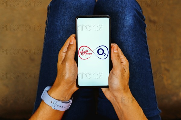 In this photo illustration, the Virgin Media O2 logo is displayed on a smartphone screen