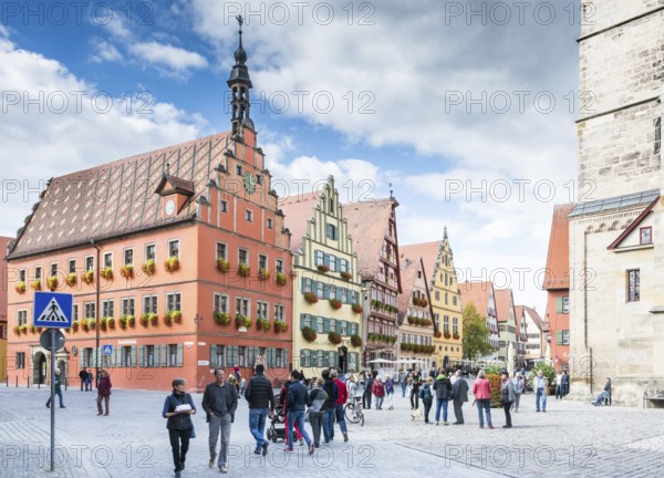 DINKELSBUEHL, GERMANY - SEPTEMBER 27: Tourists in the old town of Dinkelsbuehl, Germany on September 27, 2015. It is one of the best preserved medieaval towns in Germany. Foto taken from Marktplatz with view to the historic house facades