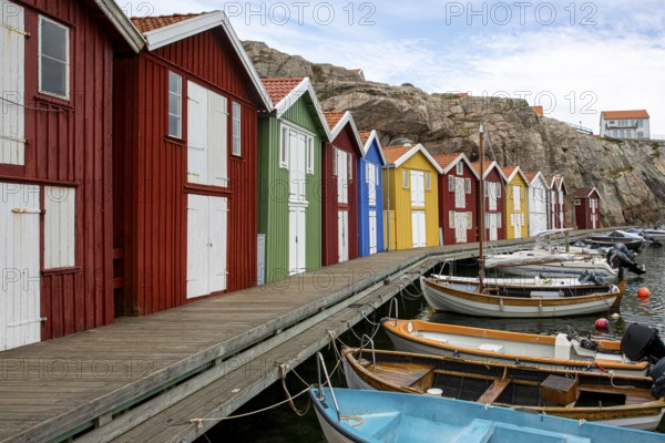 Small colourful houses by the sea. Typical houses in Sweden for the coastal landscape. Crab fishing and storage in a narrow harbour. Smögen, Smögenbryggan, Sweden, Europe