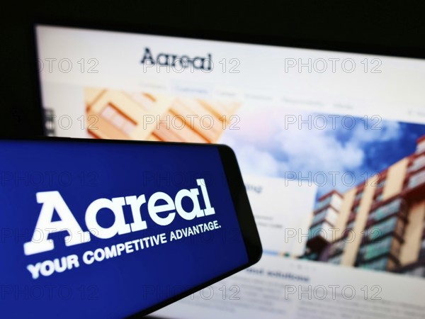 Stuttgart, Germany, 01-06-2022: Smartphone with logo of German financial company Aareal Bank AG on screen in front of business website. Focus on right of phone display, Europe