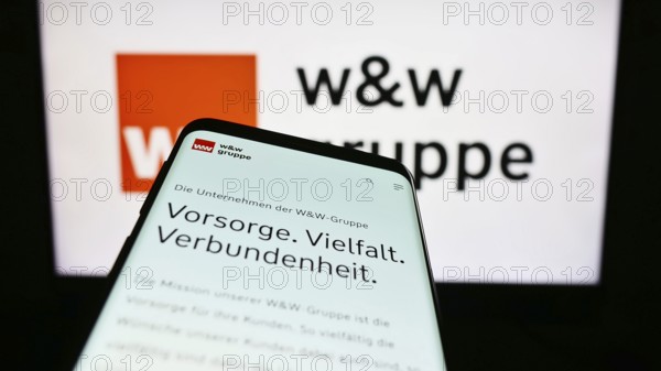 Stuttgart, Germany, 24/08/2023: Mobile phone with the website of the German company Wüstenrot Württembergische AG (WW) on the screen in front of the logo. Focus on the top left of the mobile phone display, Europe