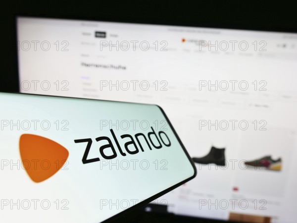 Stuttgart, Germany, 01-16-2023: Cellphone with logo of German e-commerce company Zalando SE on screen in front of business website. Focus on center of phone display, Europe