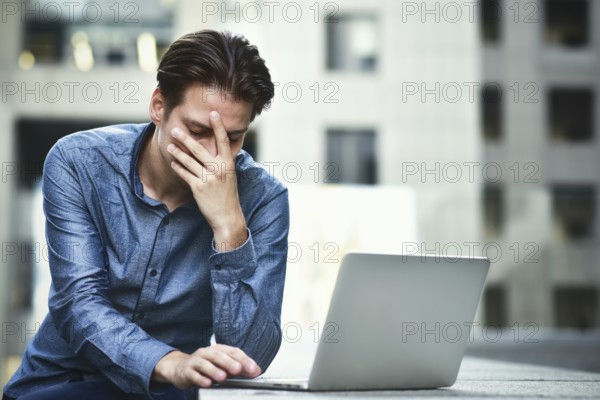 Stressed businessman after project failure. Confused young man frustrated by online problem