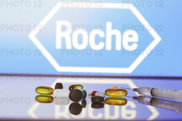May 27, 2024, Brazil. In this photo illustration, the Hoffmann?La Roche logo is displayed on screen in the background with pills and medical bottle and syringe