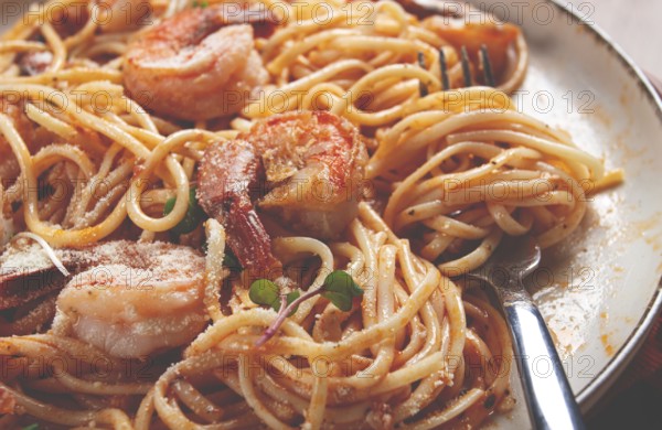Spaghetti with tiger prawns, in tomato sauce, homemade, top view, no people