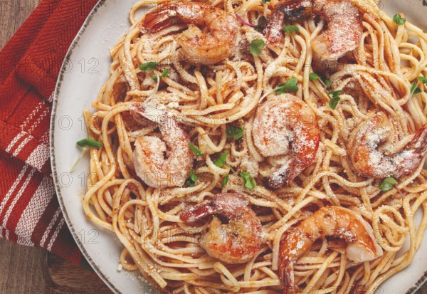 Spaghetti with tiger prawns, in tomato sauce, homemade, top view, no people