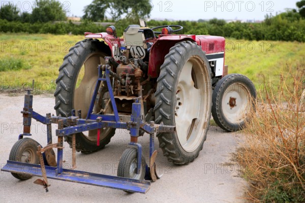 Agriculture aged red tractor retro vintage machine