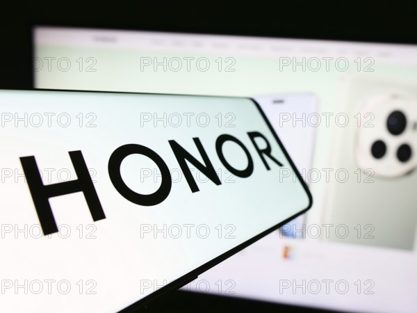 Stuttgart, Germany, 03-15-2024: Mobile phone with logo of Chinese smartphone company Honor Device Co. Ltd. in front of business website. Focus on center-left of phone display, Europe