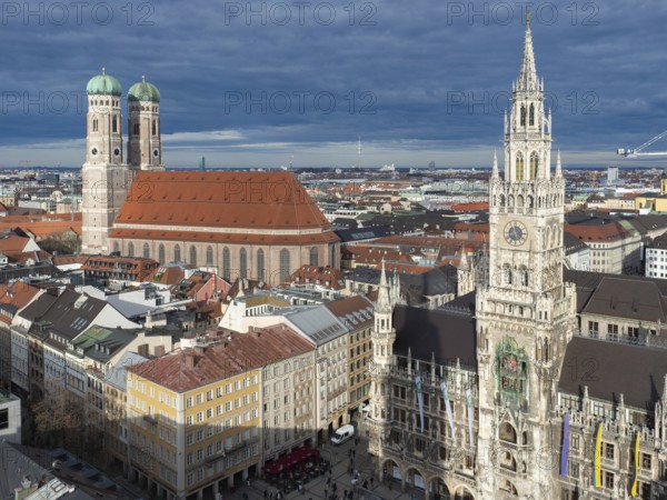 Beautiful view over the city centre of Munich, Germany: Different historic buildings with the famous Frauenkirche and the town hall in the centre. Situation on a sunny cloudy winter afternoon