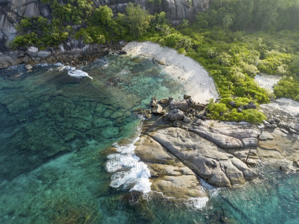 Coastline with waves, large rocks and tropical vegetation on turquoise water, aerial view, seychelles, Mahe, Port Glaud and Therese Island