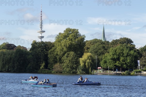 Leisure activities in summer, pedal boats against a blue sky on the Alster, with the Telemichel television tower behind, Hamburg, Germany, Europe