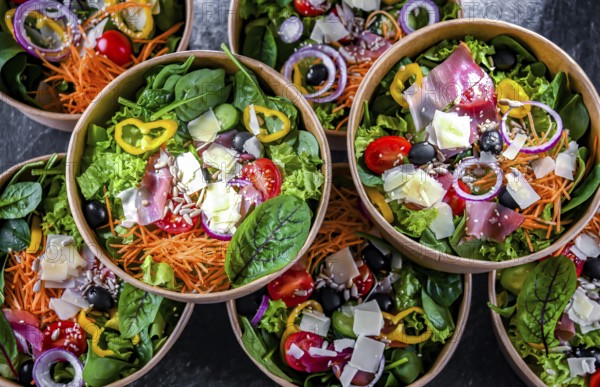 Round paper boxes with pre-packaged vegetable salads ready for sale