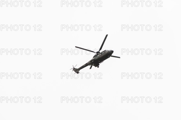 Photo of Military navy helicopter flying isolated on white background