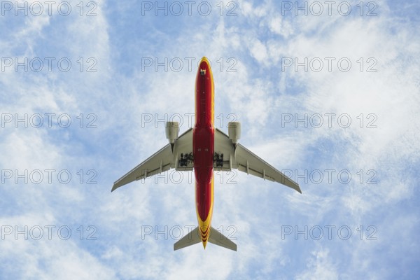 An airplane flying low on landing at Leipzig Airport