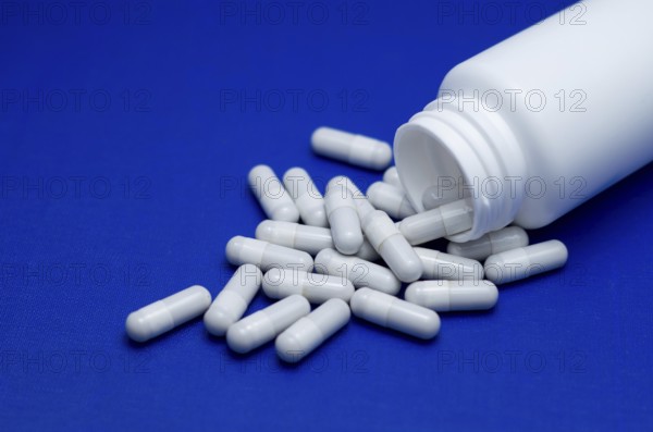 Large white pills fell from a large white bottle. Life without drugs and dependence on capsules of antibiotic, medicine, amphetamines, drugs and drugs. Concept of drug withdrawal drugs. Bulgaria