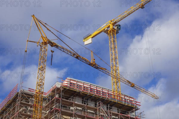 Construction site, shell of a residential building with construction cranes, Bremen, Germany, Europe