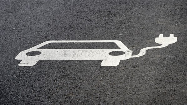 Indication of an electric charging station on the asphalt of a street in Leipzig