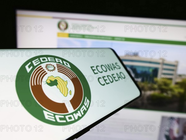 Stuttgart, Germany, 02-15-2024: Smartphone with logo of Economic Community of West African States (ECOWAS) in front of website. Focus on center-left of phone display, Europe