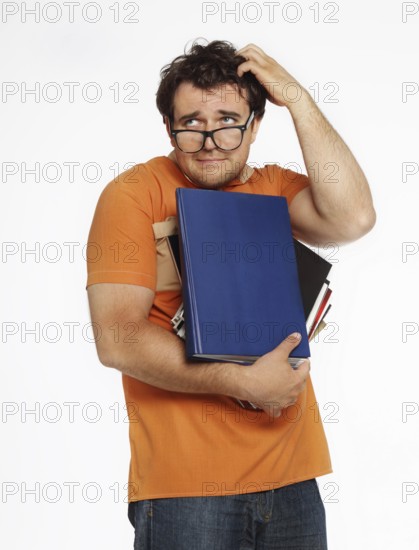 Young man in glasses holding bunch of books