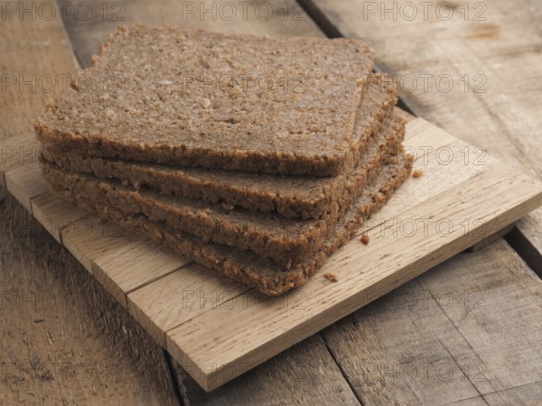 Wholemeal rye bread on a rustic wooden table, healthy food concept