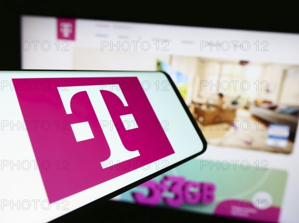 Stuttgart, Germany, 09-11-2023: Mobile phone with logo of telecommunications company Deutsche Telekom AG on screen in front of website. Focus on center of phone display, Europe