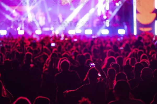 Crowd of people in front of the stage during the concert. Poland