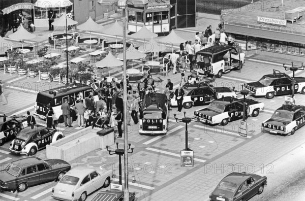 The Norrmalmstorg robbery 23-28 august 1973. Kreditbanken on Normmalmstorg in Stockholm. The first criminal event in Sweden to be covered by live television. Jan-Erik Olsson was the robber and was joined by former cellmate and friend Clark Olofsson in the bank. The robbers gave up after that the police used teargas, no one of the hostages was hurt. A bank robbery and hostage crisis best known as the origin of the term Stockholm syndrome that is a proposed condition in which hostages develop a physological bond with their captors. Picture shows the police gathered in the square during the robbery