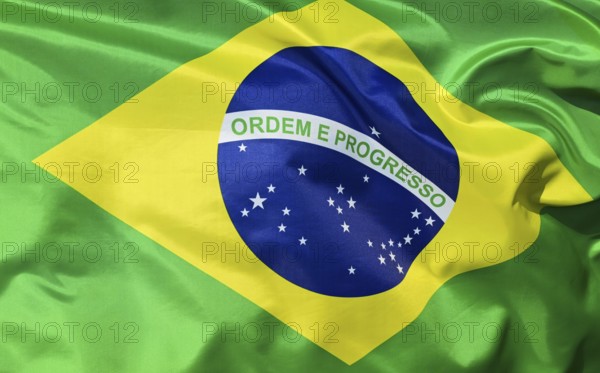 Close-up of the Brazilian national flag fluttering in the wind with folds and wave patterns