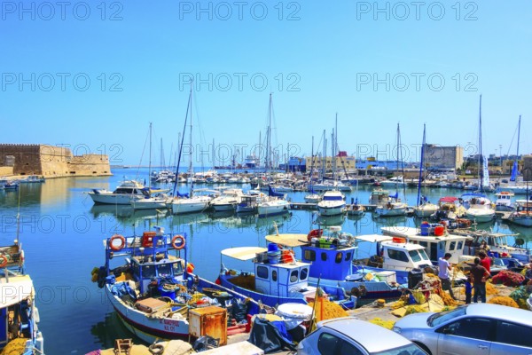 Heraklion, Greece, April 27, 2019: Crete island old harbor with fishing boats and Venetian fortress of Rocca al Mare, Europe