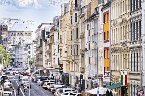House facades from the end of the 19th century in the Belgian Quarter and the medieval church of St Gereon in Cologne in July 2023