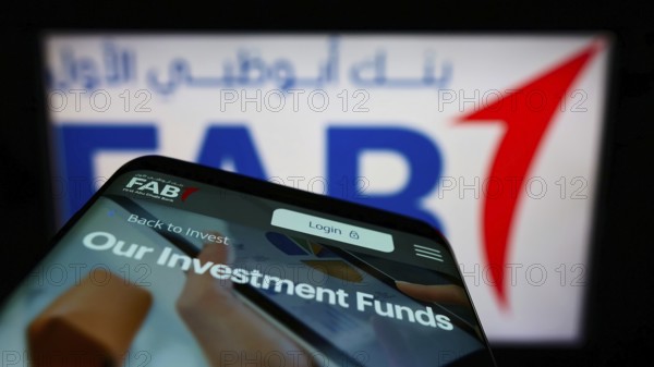 Stuttgart, Germany, 02-11-2022: Smartphone with webpage of financial company First Abu Dhabi Bank (FAB) on screen in front of business logo. Focus on top-left of phone display, Europe