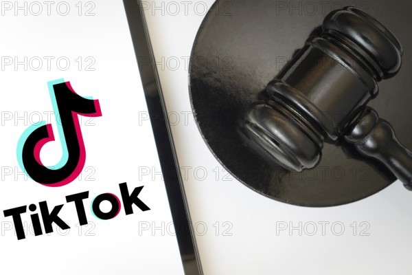 An iPad displays the tiktok logo alongside a judge's gavel