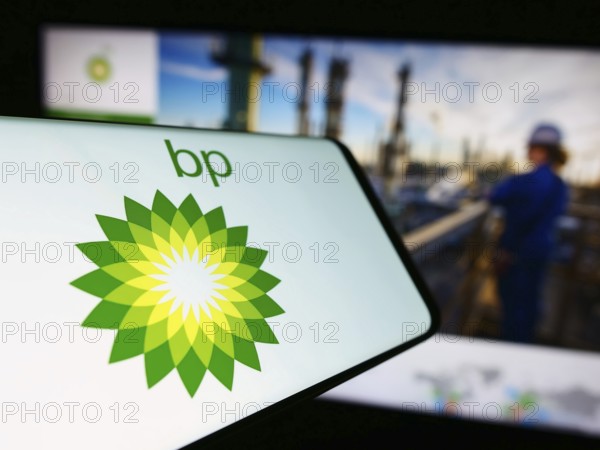 Stuttgart, Germany, 11-16-2023: Cellphone with logo of British oil and gas company BP plc in front of business website. Focus on center-left of phone display, Europe