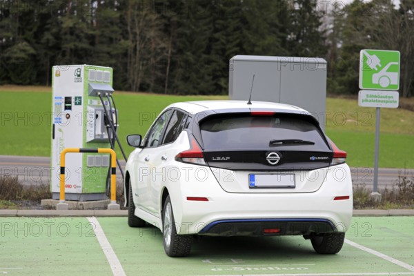 Salo, Finland, November 23, 2018: Nissan Leaf electric car charging battery at Fortum Charge & Drive Fast Charger in South of Finland, rear view, Europe