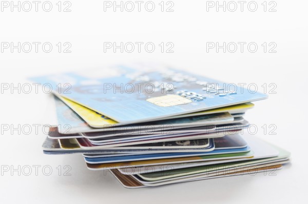 A pile of several colored credit cards